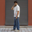 Fish & Flow shirt side view showing embroidered hem