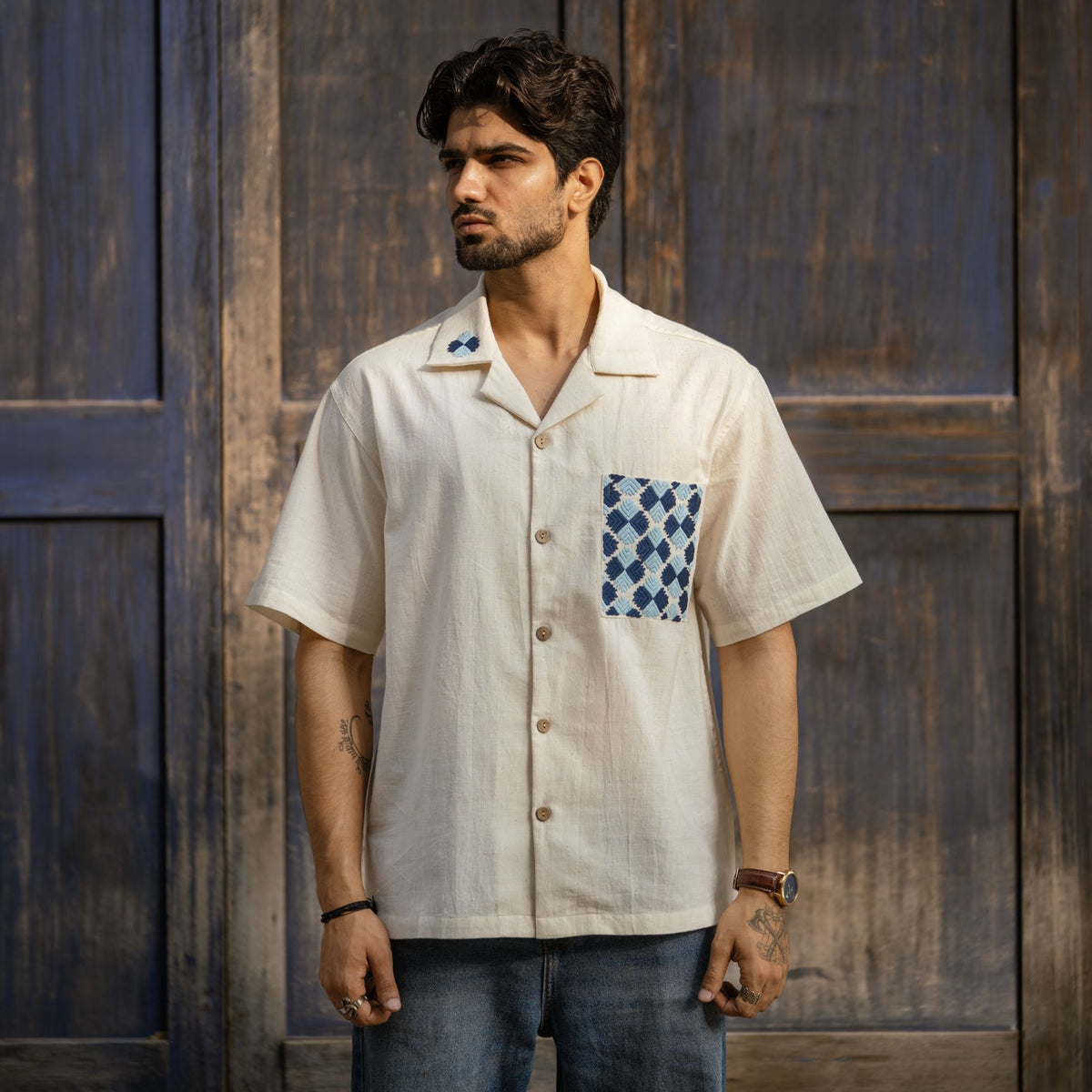 Phulkari shirt front view against wooden door