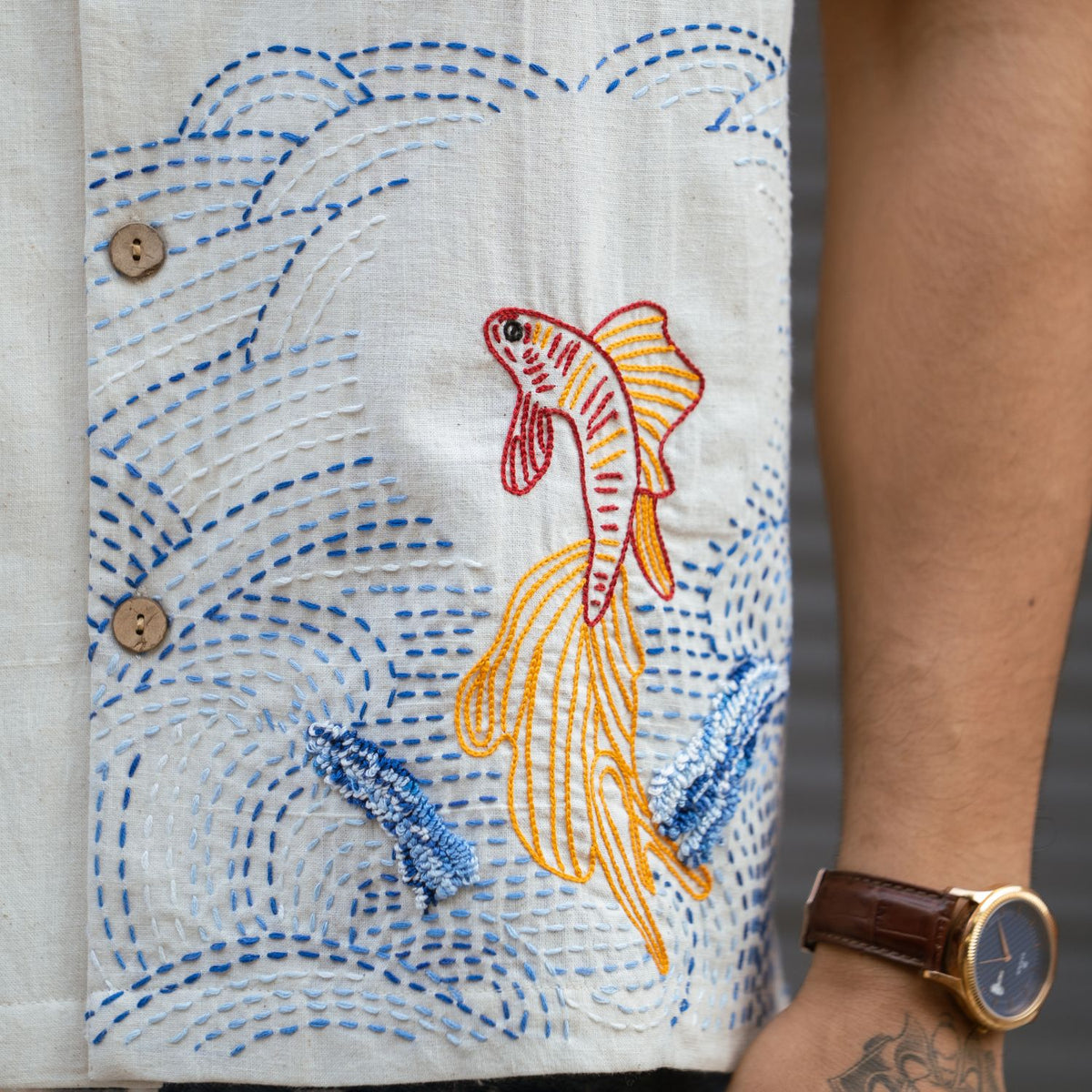 Close-up of hand-embroidered fish and Kantha work on handloom Khadi