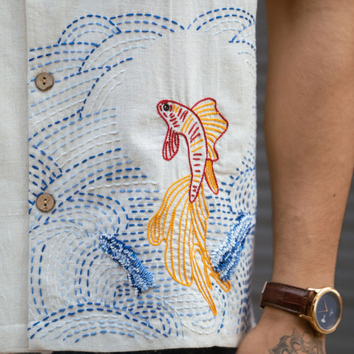 Close-up of hand-embroidered fish and Kantha work on handloom Khadi
