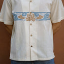 Close-up of hand-appliqued wave and flower motifs on ecru handloom khadi shirt