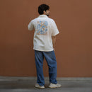 Full back view of Sea Drift ecru khadi shirt styled with blue denim and sneakers