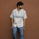 Man wearing Sea Drift half sleeve khadi shirt with hand-appliqued wave pattern
