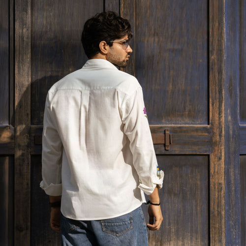 Back view of Valley of Blooms white cotton-linen shirt with embroidered sleeve flowers
