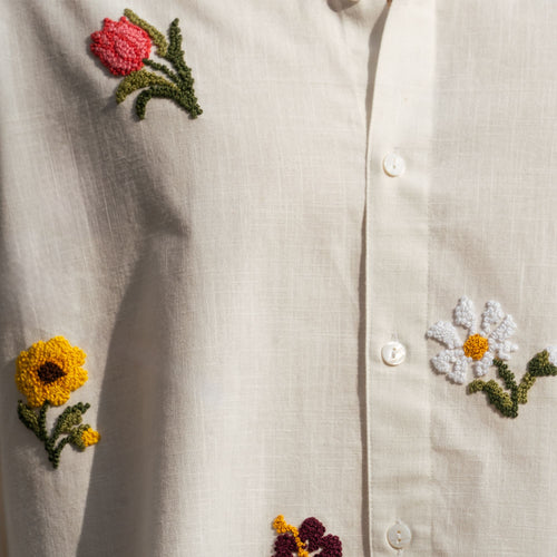 Close-up of hand-done French knot floral embroidery on cotton-linen shirt
